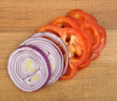 sliced onion and pepper on a wooden board