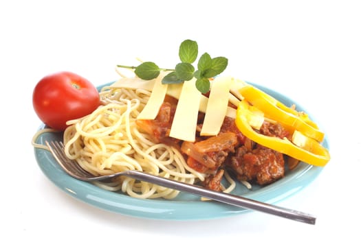Pasta and ingrediients on a dish against a white background