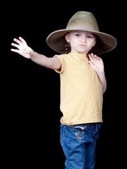 A beautiful young girl in an oversized hat.  She is reaching out for something, or could be dropping something.