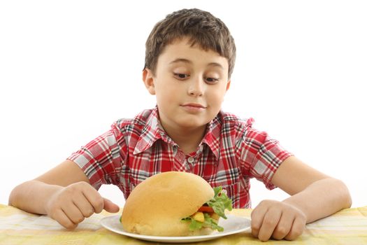 boy eating a big hamburger close up