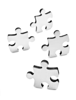 Stainless steel puzzle pieces on white background with space for text