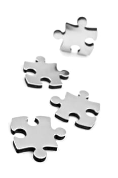 Stainless steel puzzle pieces on white background with space for text