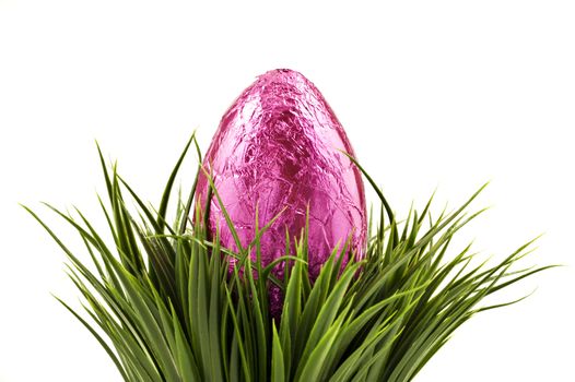 Colorful easter eggs in grass on a white background