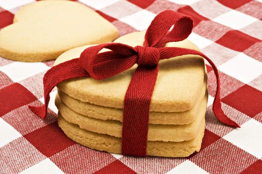 Heart shaped cookies with red ribbon on cloth