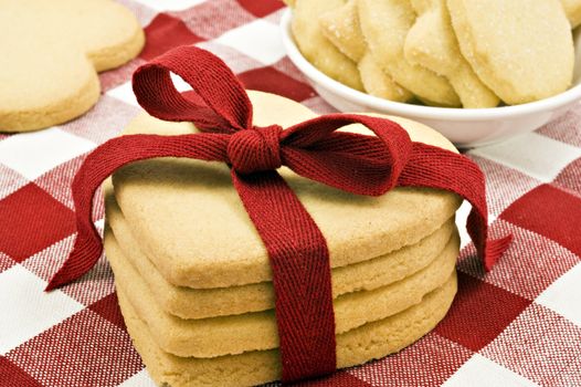 Heart shaped cookies with red ribbon on cloth