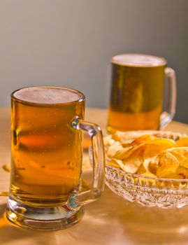  full mugs booze lager and potato chips
