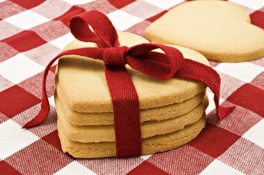 Heart shaped cookies with red ribbon on cloth