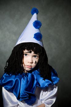 portrait child in costume Piero  on gray background