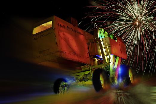 An old harvesting machine painted with light and some fireworks.