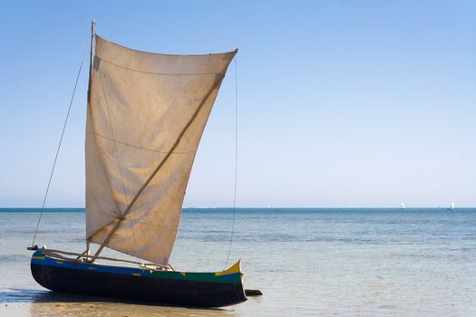 Malagasy outrigger pirogue with makeshift sails