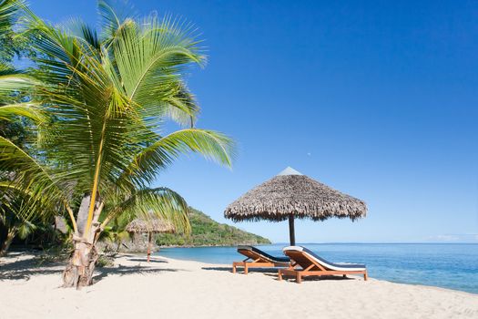 Tropical beach landscape with deckchair and parasol, from Nosy Be, Madagascar