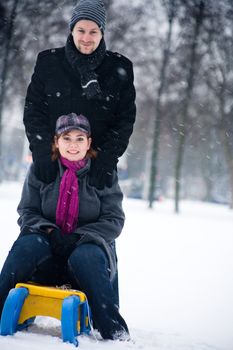 Happy couple in the snow having some fun together