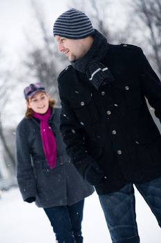 Happy couple in the snow having some fun together