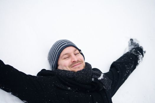 Happy couple in the snow having some fun together