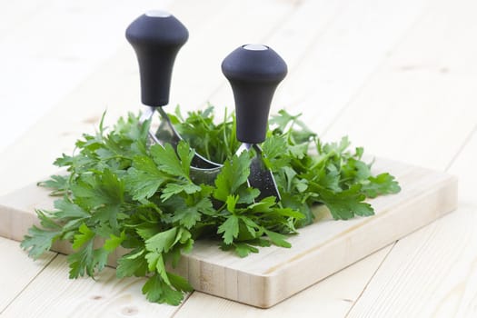 Freshly chopped parsley on wooden cutting board