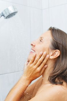 Young beautiful smile woman in shower enjoy