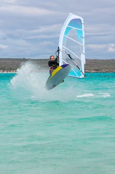 Windsurfer jumping a wave in the lagoon, Babaomby, Madagascar