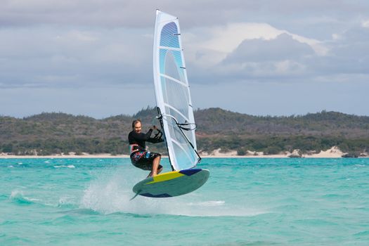 Windsurfer jumping a wave in the lagoon, Babaomby, Madagascar