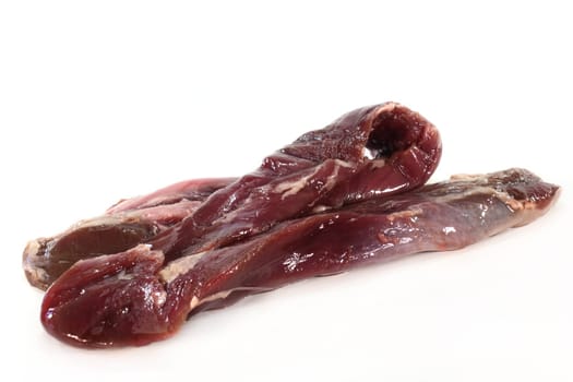 two raw lamb fillets on a white background