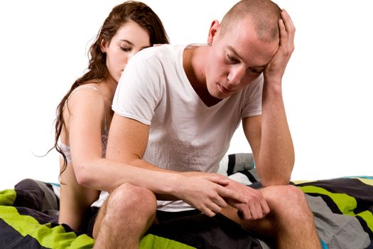 A young couple in bed with relation problems