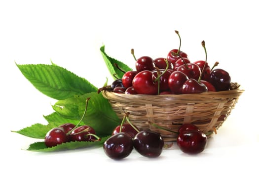 fresh red cherries in a small basket