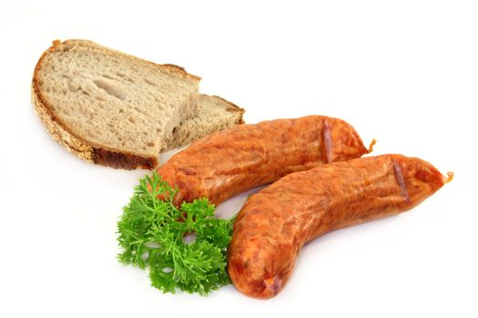 two sausages with bread and parsley on a white background