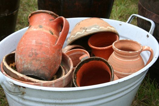 different ceramic pots in an old tub