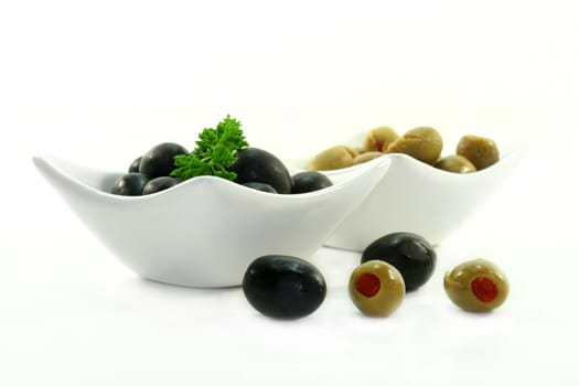 black and green olives in small white bowls