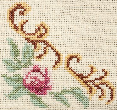 Old retro corner embroidery with rose and leaves