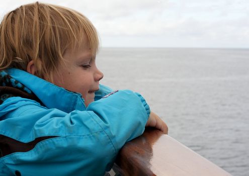 Cute little child looking out on the sea