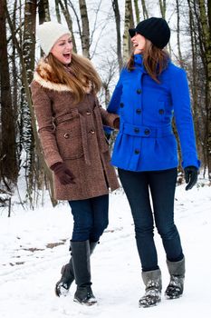 two sisters having fun during a winter walk