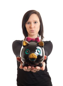 closeup of a young woman presenting a piggy bank to the camera