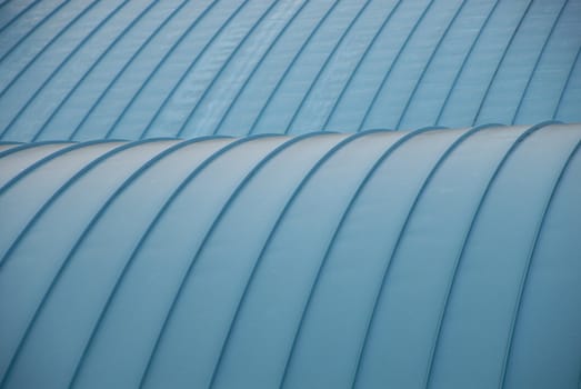 A close view of a curved blue roof