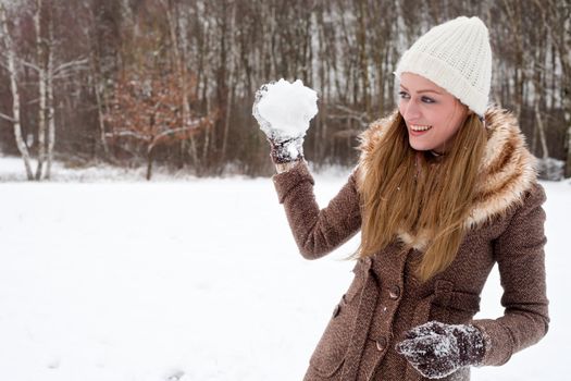 beautiful woman about to throw a snow ball