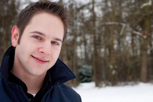 Friendly smiling young man in winter