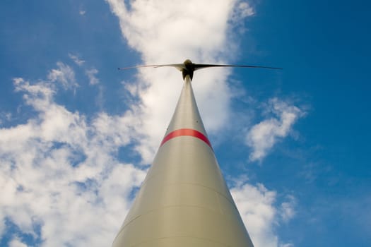 Wind turbine, a bottom view, against the background of the cloudy sky
