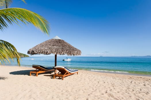 Tropical beach landscape with deckchair and parasol, from Nosy Be, Madagascar