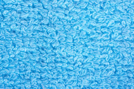 Closeup view of blue towel. Fluffy blue background