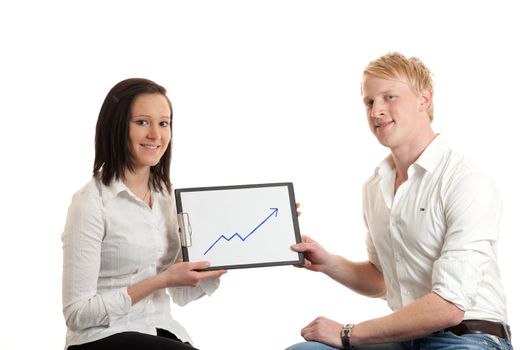 two young businesspeople presenting a cliboard with a chart indicating  growth