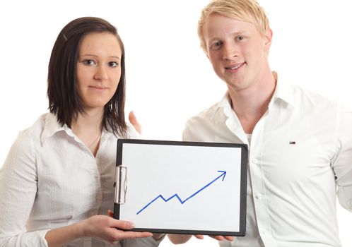 closeup of two young businesspeople presenting a cliboard with a chart indicating  growth