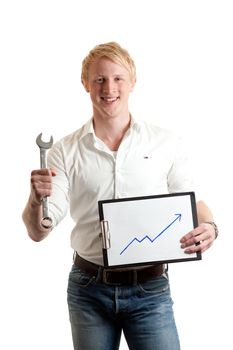 a young businessman holding a chart indicating growth and a wrench