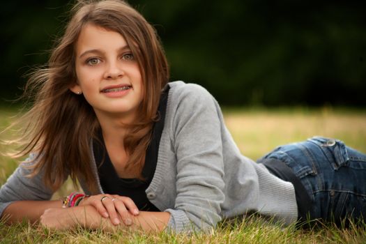 Young summer girl portrait in the grass