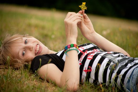 Young summer girl portrait in the grass