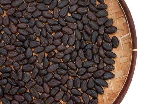 Cocoa beans from Madagascar in craft basket isolated on white background