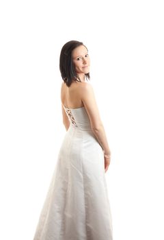 a young woman in a white dress looking backward over her shoulder isolated on white