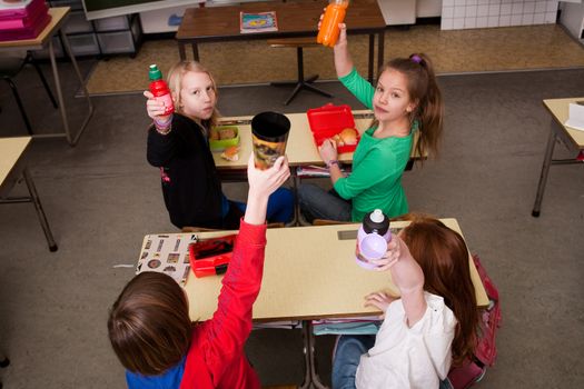 Group of little students with different ages in a classroom