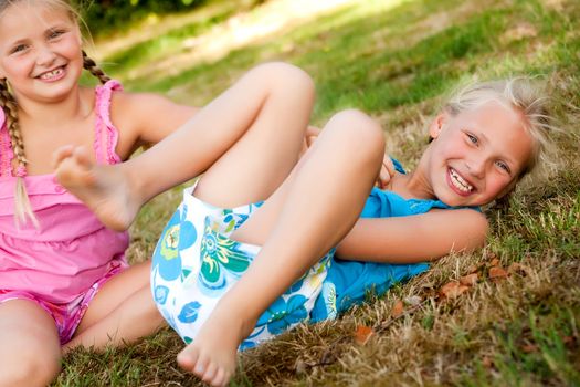 Two little girls in fresh colors in the park