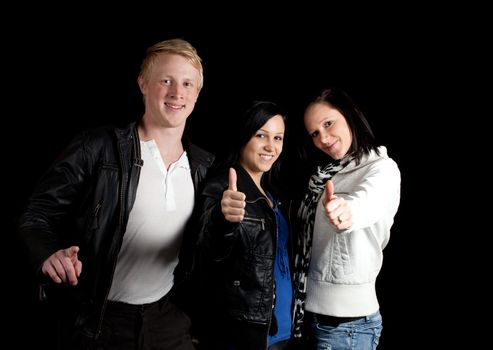 a small group of young people posing with thumbs up