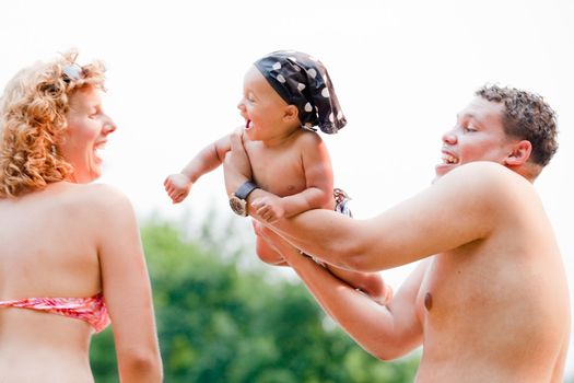 The family and a happy babys first day out in the park