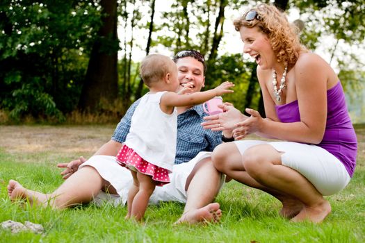 The family and a happy babys first day out in the park